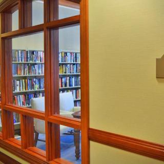 Interior view of a library reading room with bookshelves and seating.