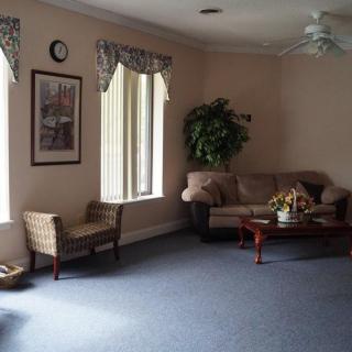A cozy living room with a sofa, coffee table, and indoor plants.