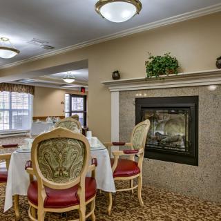 Elegant dining room with a cozy fireplace and classic furnishings.