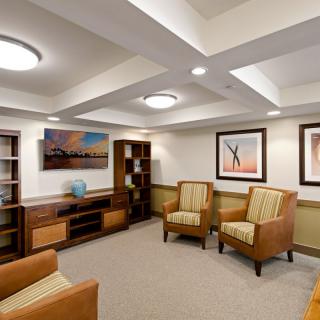A modern waiting room with comfortable chairs and elegant artwork.