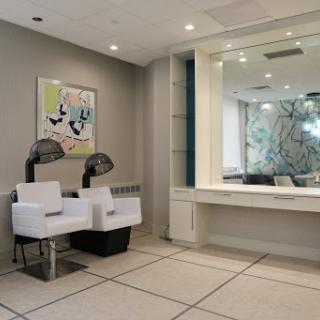 A modern and inviting waiting area featuring sleek furniture and contemporary artwork.