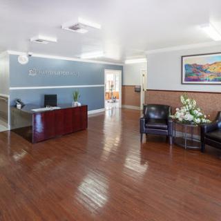 A spacious and well-lit office lobby with comfortable seating and a reception desk.