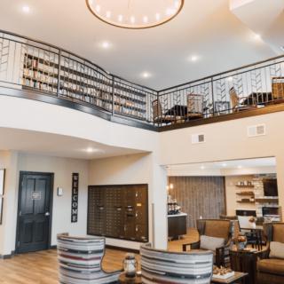 A modern living room with a mezzanine, featuring cozy seating and stylish decor.