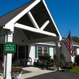 A welcoming entrance with a patriotic theme, featuring a porch and an American flag.