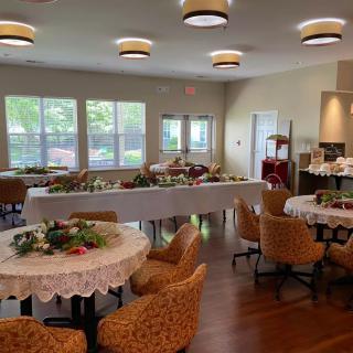 A decorated dining area prepared for a banquet event with arranged tables and chairs.