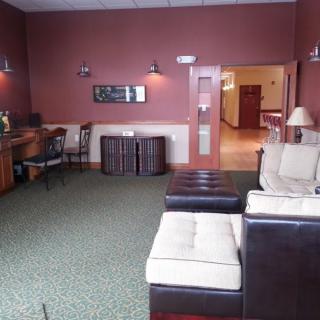 A cozy lounge area with comfortable seating and a warm color scheme.