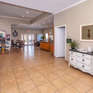 A bright and welcoming lobby area with tiled flooring and stylish furnishings.