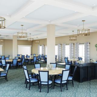 A spacious dining room with neatly arranged tables and chairs, featuring large windows and elegant chandeliers.