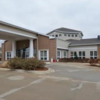 An exterior view of a building with a driveway and entrance.