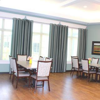 A spacious dining area with elegant furniture and natural light.