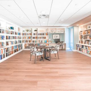 A bright and inviting library space featuring ample bookshelves and a cozy reading area.