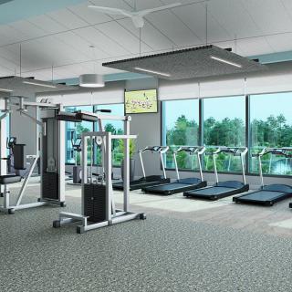 A modern gym with various exercise equipment, including treadmills and a weight machine.