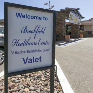 Entrance sign for Brookfield Healthcare Center with valet service.