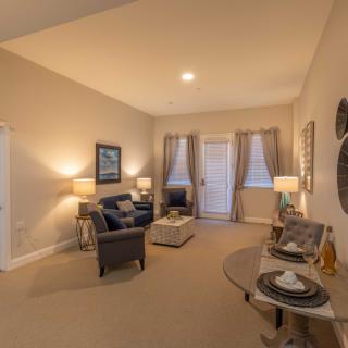 A cozy living room with comfortable seating, ambient lighting, and stylish decor.