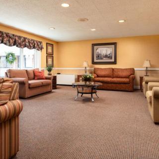 A cozy living room with comfortable couches, a coffee table, and warm lighting.