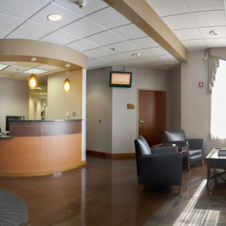 A modern reception area featuring comfortable seating and a flat-screen TV.