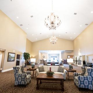 A spacious lobby area with elegant chandeliers and comfortable seating.
