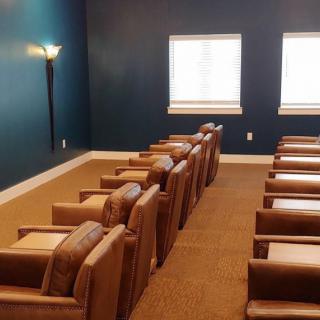 A home theater room with comfortable seating and blue walls.