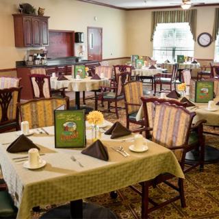 A neatly arranged dining room with tables set for a meal.