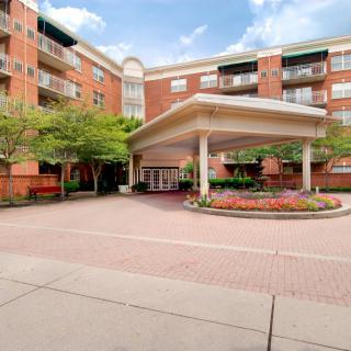 A residential apartment building with a landscaped entrance area.