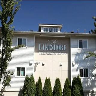 A residential apartment building named 'Lakeshore' with a clear blue sky in the background.