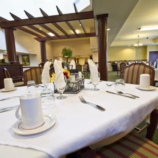 An elegantly set dining table in a spacious restaurant interior.