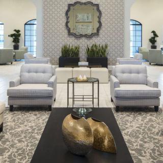 Sophisticated modern living room with plush seating and abstract decor.