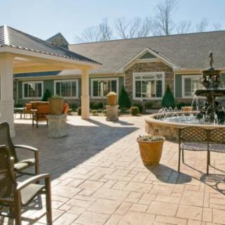 A spacious courtyard with a fountain and outdoor seating area.