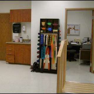 A rehabilitation facility with exercise equipment and an office area.