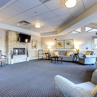 A spacious and modern living room with comfortable seating and a fireplace.
