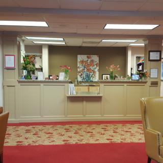 A well-lit office reception area with comfortable seating and decorative accents.