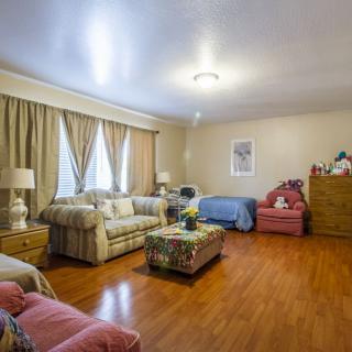 A cozy living room with comfortable seating and wooden flooring.
