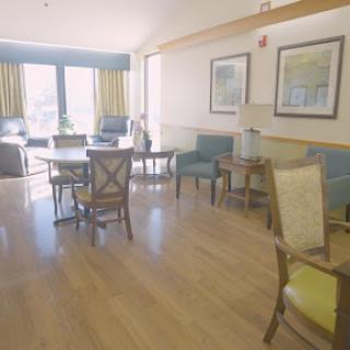A bright and spacious living area with comfortable furniture and large windows.