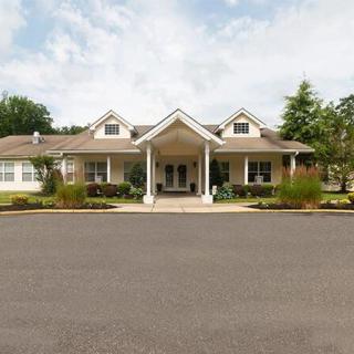 A suburban residential house with a well-maintained front yard and driveway.