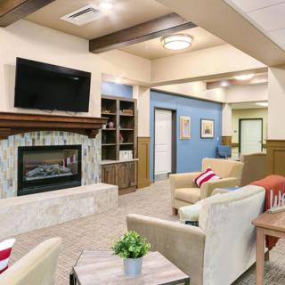 A modern living room with a fireplace, television, and comfortable seating area.