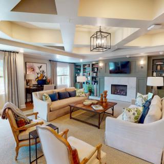 A beautifully decorated modern living room with a cozy ambiance and elegant furniture.