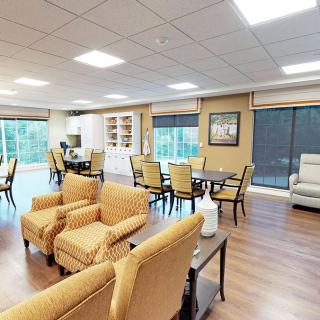 A cozy and well-lit living space with comfortable seating and dining areas.