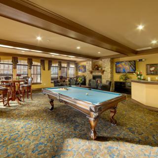 A cozy recreation room featuring a pool table and seating area.