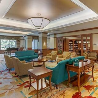 A cozy lounge area with comfortable seating and a library section.