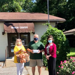 Community members come together to make a donation outside the local community center.