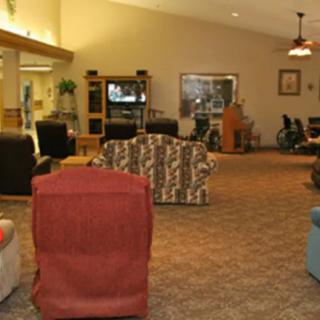 A cozy living room with various seating options and a television.
