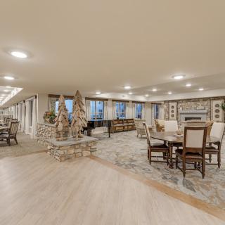 A spacious and elegant living area with a fireplace, featuring comfortable seating and dining spaces.