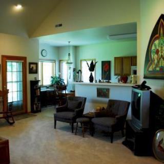 A cozy living room with comfortable seating, a television, and various decorative elements.
