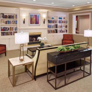 A cozy living room with modern furniture and built-in bookshelves.