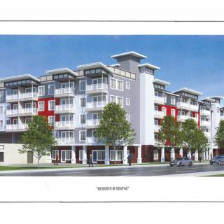 A modern, multi-story residential building with a contemporary design.