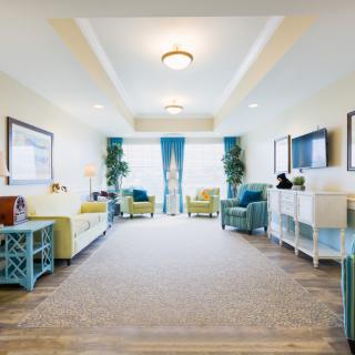 A bright and modern living room with stylish furniture and decorative elements.