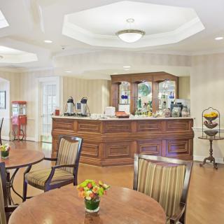 A cozy cafe interior with wooden furniture and a coffee station.
