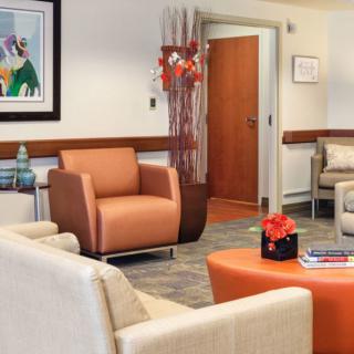 A cozy waiting room with comfortable seating and colorful artwork.