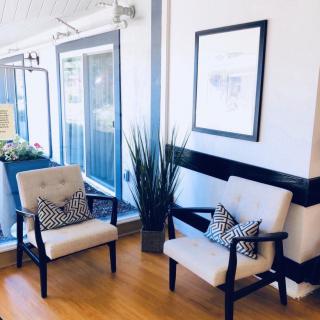 A modern waiting area with two chairs and decorative elements.