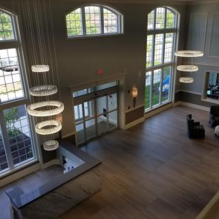 A spacious and modern lobby with large windows and contemporary lighting.
